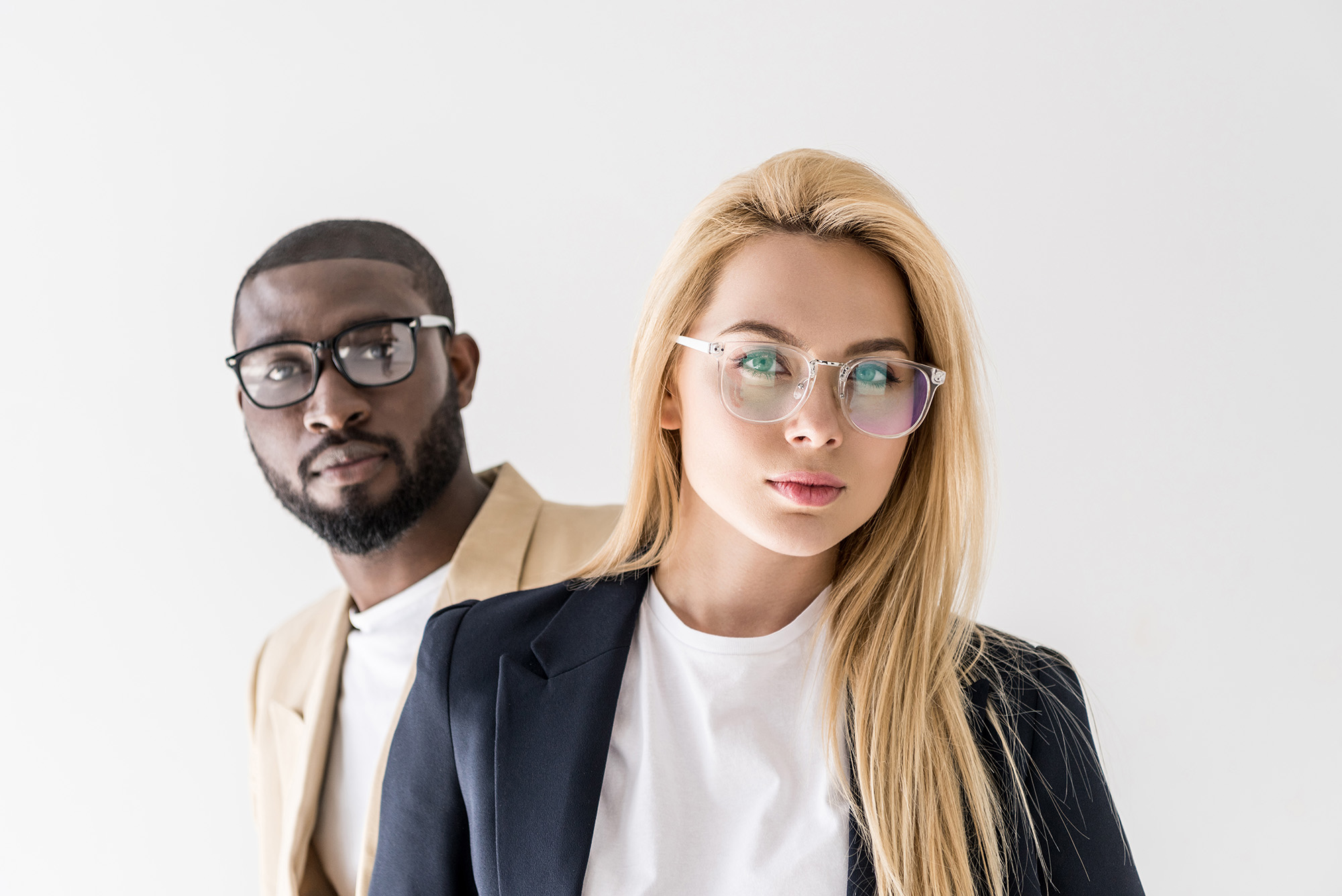 A beautiful multiracial couple wearing stylish eyeglasses